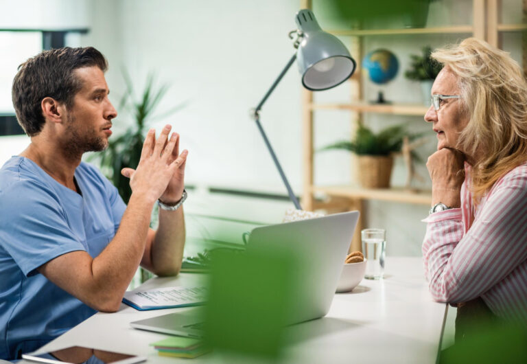 side-view-general-practitioner-communicating-with-senior-woman-doctor-s-office